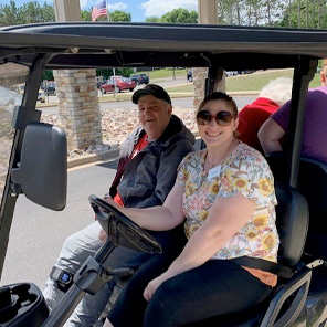 Senior getting a ride in a golf cart